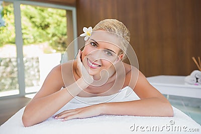 Beautiful woman lying on massage table at spa center