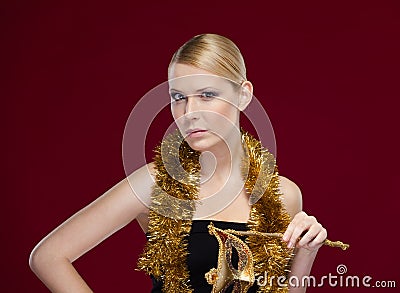 Beautiful woman with masquerade mask and tinsel