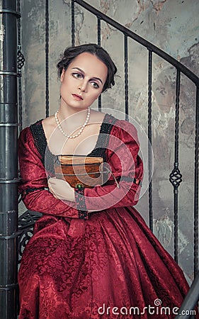 Beautiful woman in medieval dress with book