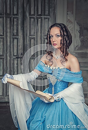 Beautiful woman in medieval dress with scroll letter