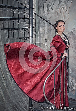 Beautiful woman in medieval dress on the stairway