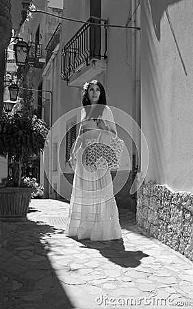 Beautiful woman on the medieval street of italian town