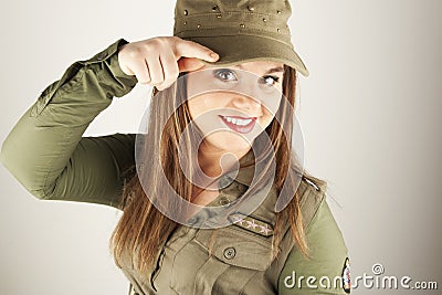 Beautiful woman in military clothes saluting