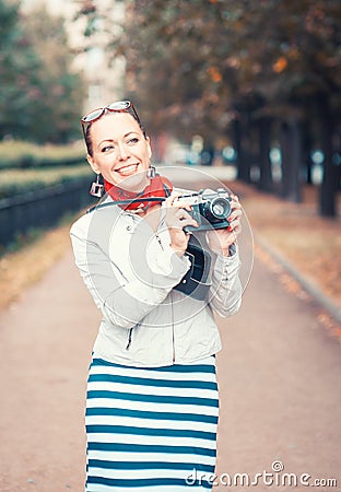 Beautiful woman with old retro camera