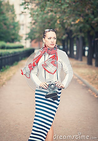 Beautiful woman with old retro camera