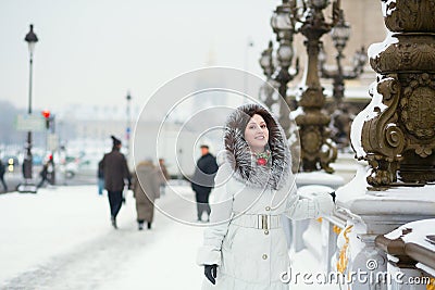 Beautiful woman in Paris on a snowy day