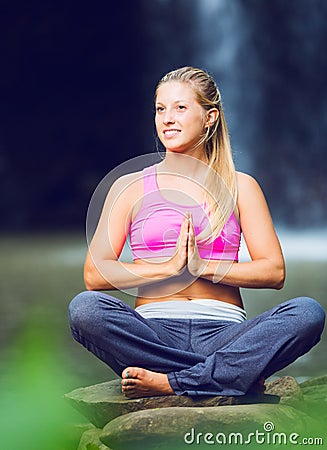 Beautiful Woman Practicing Yoga Outside In Nature