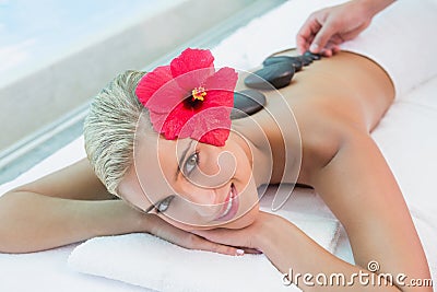 Beautiful woman receiving stone massage at health farm