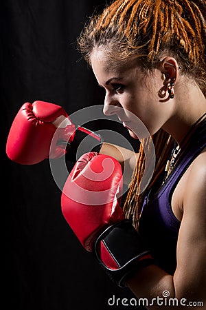 Beautiful woman with red boxing gloves, dreadlocks