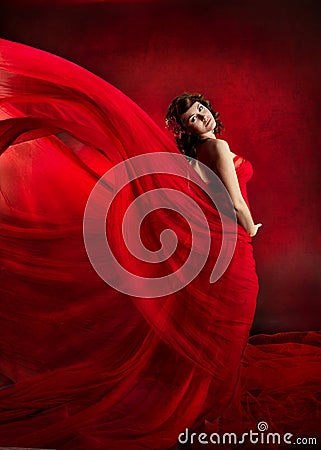 Beautiful woman in red flying waving dress.