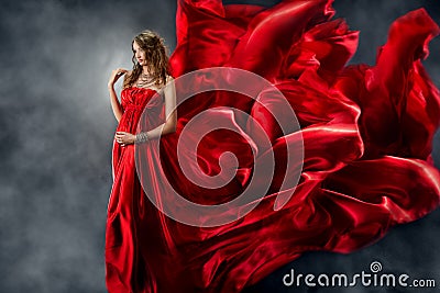 Beautiful woman in red waving silk as flame