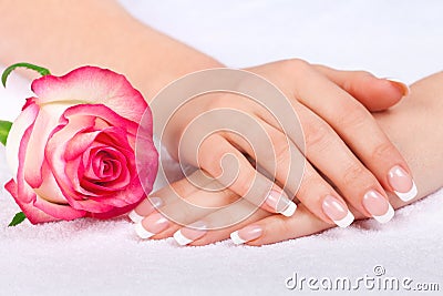 Beautiful woman s hand with perfect french manicure near