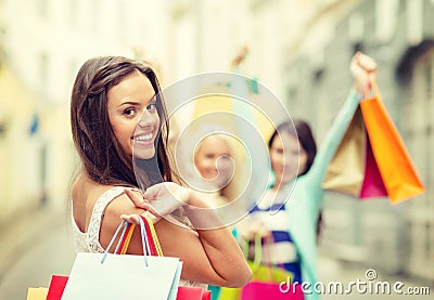 Beautiful woman with shopping bags in the ctiy