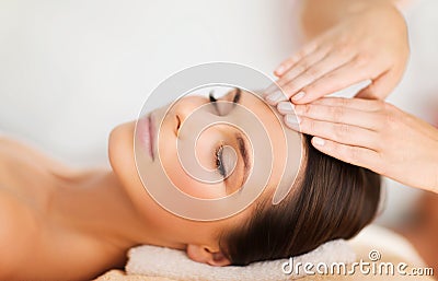 Beautiful woman in spa salon having facial