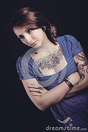 Beautiful woman with tattoo in black background