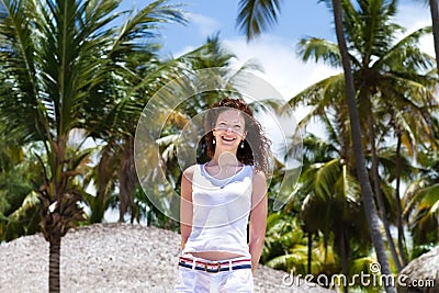 Beautiful woman under tropical palm trees