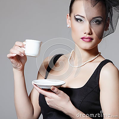 Beautiful woman in veil retro beauty portrait with cup of tea or