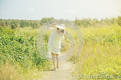 Beautiful woman walking in the summer park