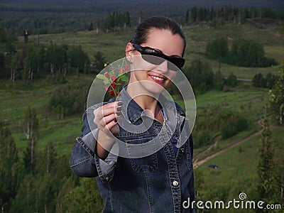 The beautiful woman with wild strawberry berries