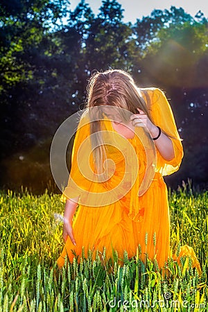 Beautiful woman in yellow dress posing