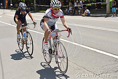 Beautiful women riding bicycles in a sunny day, competing for Road Grand Prix event, a high-speed circuit race in Ploiesti-Romania