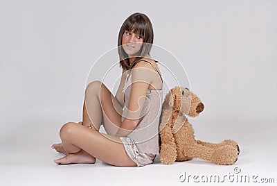 Beautiful young blond woman with teddy bear