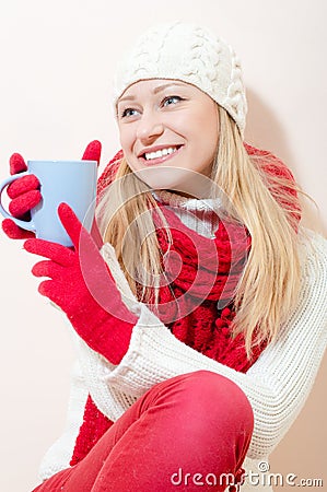 Beautiful young blonde woman in red knitting