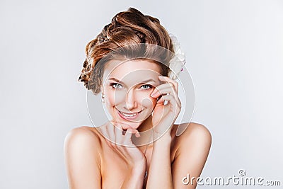 Beautiful young bride smiling on white background