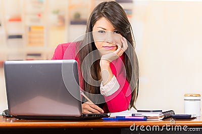 Beautiful young brunette girl working with laptop