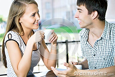 Beautiful young couple at cafe