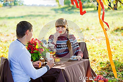 Beautiful Young Couple Having Picnic in autumn Park. Happy Famil