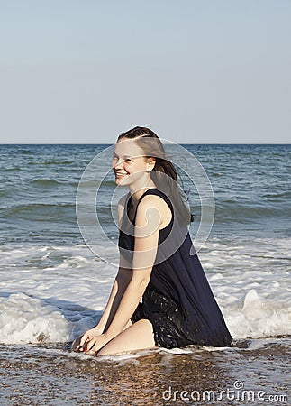 Beautiful young girl in black wet dress