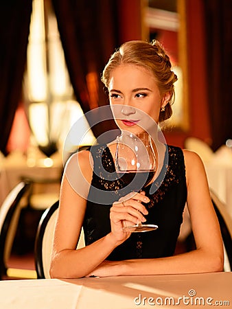 Beautiful young girl with glass of red wine