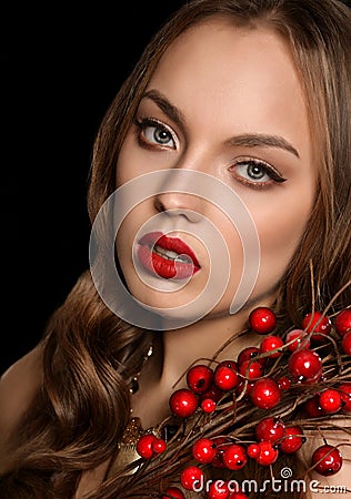 Beautiful young girl with red berries