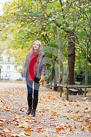 Beautiful young girl walking on a fall day