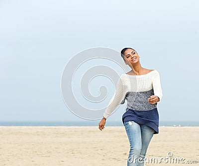 Beautiful young lady walking on the beach