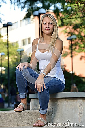 http://thumbs.dreamstime.com/x/beautiful-young-latina-student-hispanic-woman-blonde-hair-wearing-white-tank-top-blue-jeans-portrait-seated-44685895.jpg