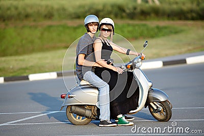 Beautiful young love couple on scooter