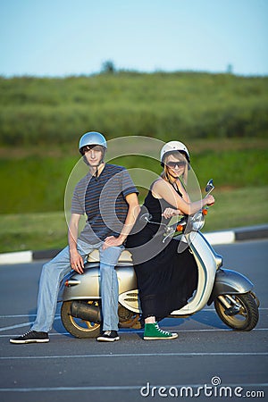 Beautiful young love couple on scooter