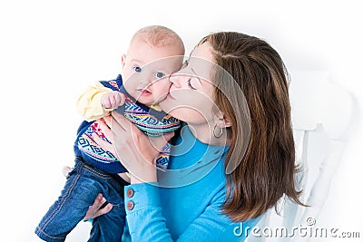 Beautiful young mother kissing her little baby boy