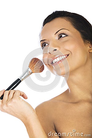 Beautiful young woman applying foundation powder or blush with makeup brush, isolated on white background