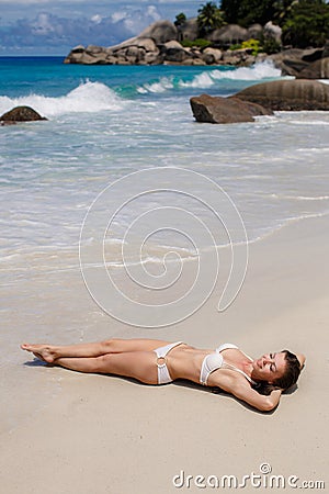 A beautiful young woman in a bikini with surfboard