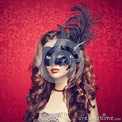 Beautiful young woman in black mysterious Venetian mask