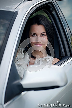 Beautiful young woman driving a car