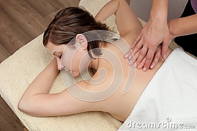 Beautiful young woman getting a back massage
