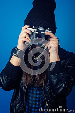 Beautiful young woman holding camera