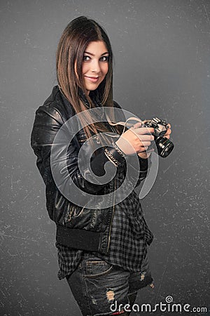 Beautiful young woman holding camera