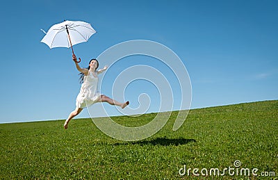 Beautiful young woman jumping with white umbrella