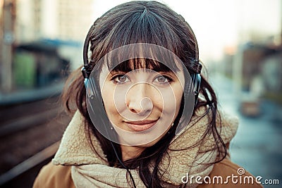 Beautiful young woman listening to music headphones