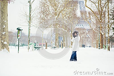 Beautiful young woman in Paris on a snowy day